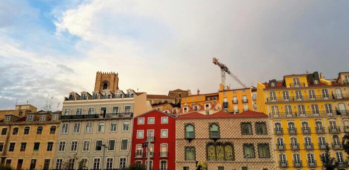 A view of Lisbon houses against the skyline with a crane visible.