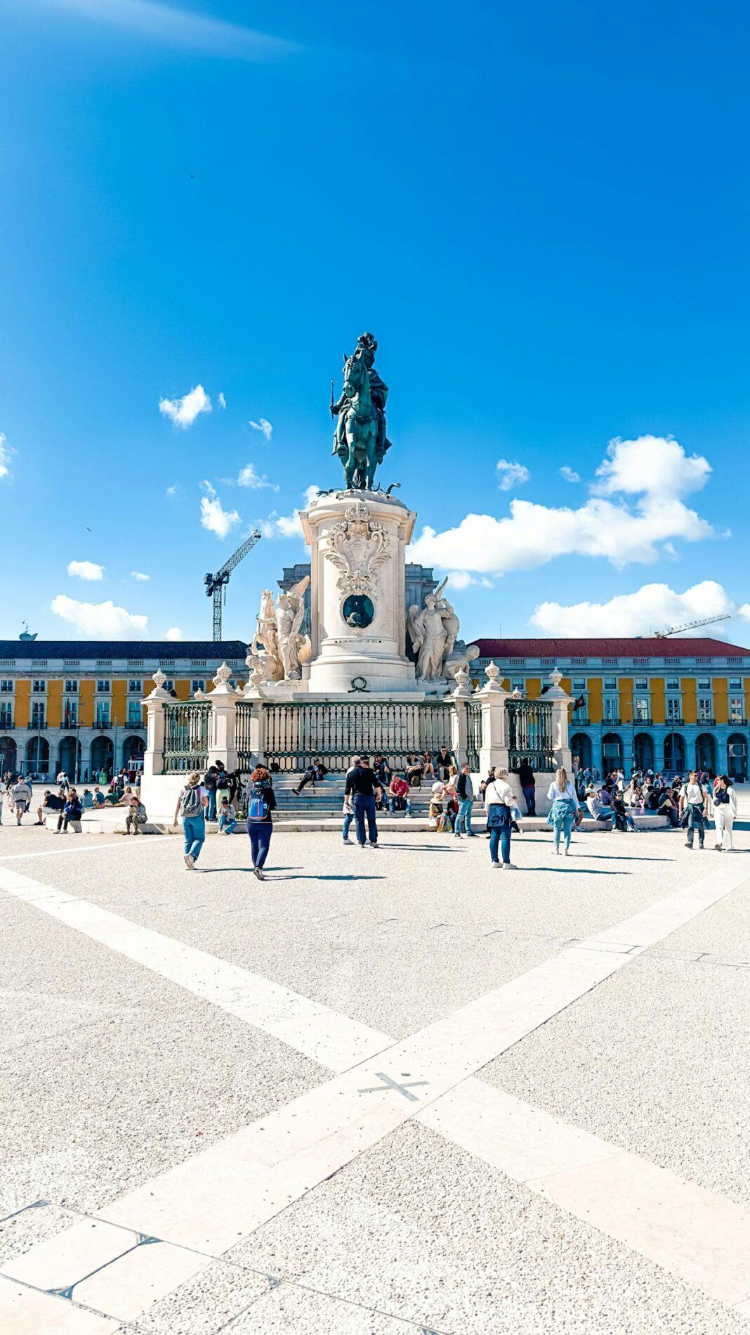 An image of a Lisbon square with a bright blue sky