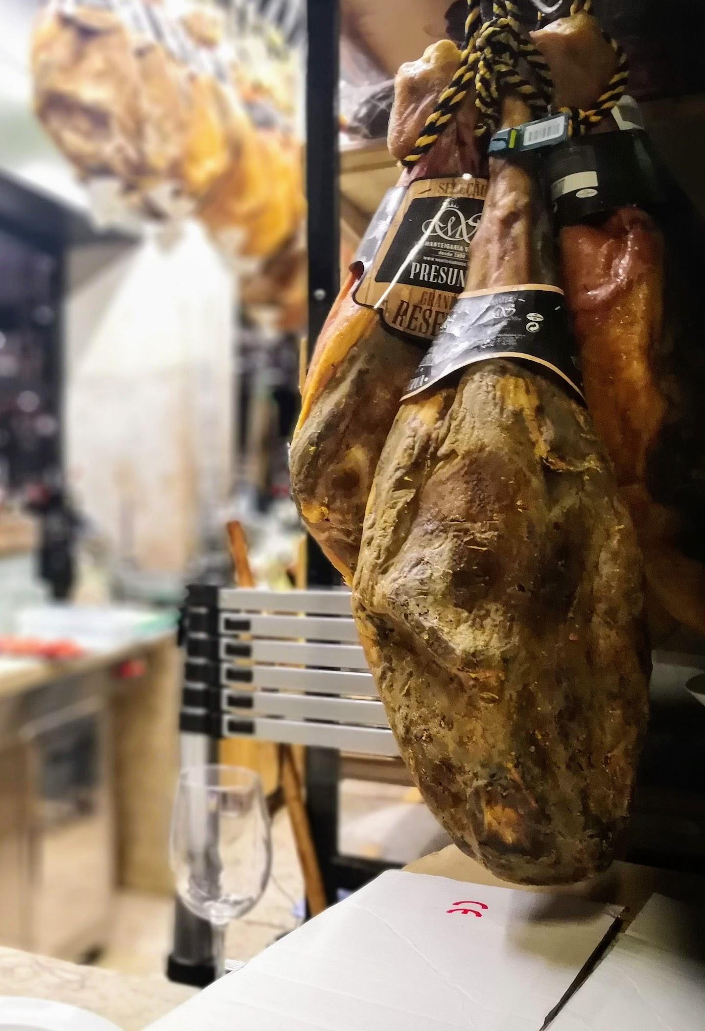 Cured meat hanging at a food market in Lisbon