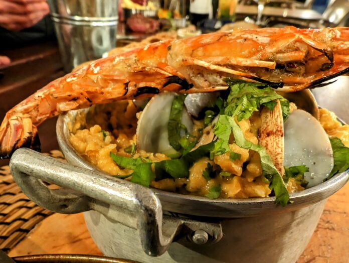 Portuguese bread soup with a large prawn laid over the top of the dish