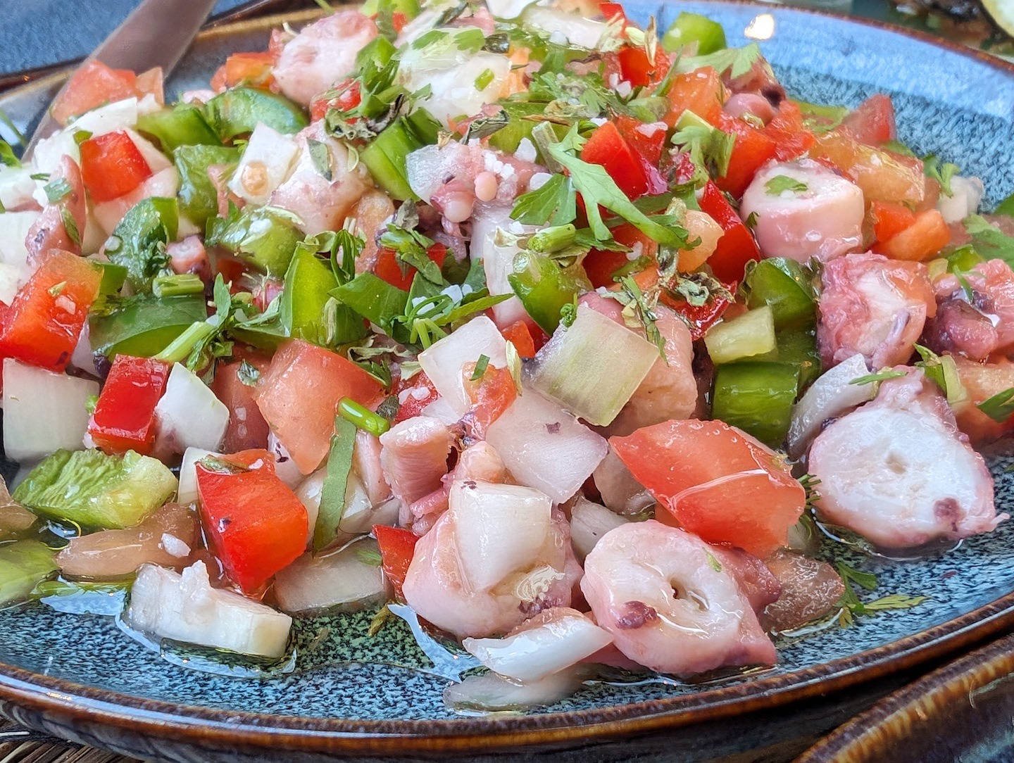 A diced octopus salad with onions and peppers