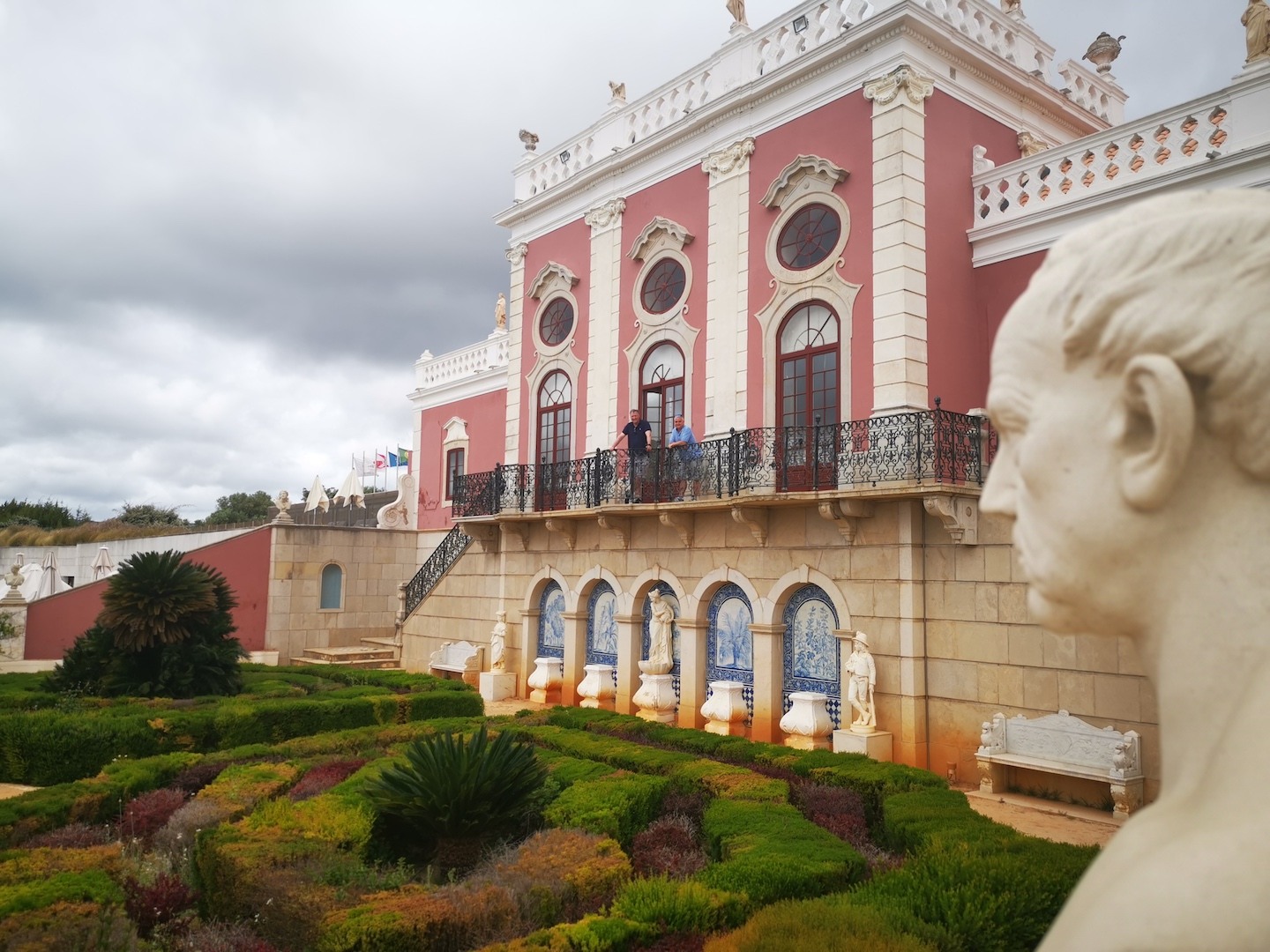 Palace of Estoi in Portugal, with an antique bust and gardens in teh foreground