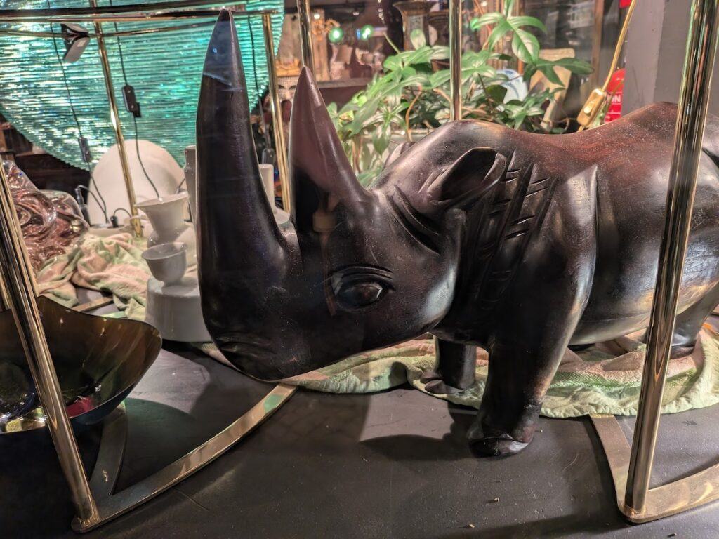 A carving of a rhinoceros in a shop window