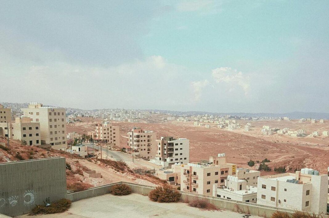 A view of a city in Lebanon wh a light blue, cloudy sky