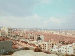 A view of a city in Lebanon wh a light blue, cloudy sky