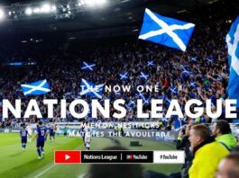 Scottish fans cheering in a stadium during a match.