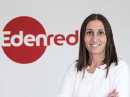 Filipa Martins in a business setting, smiling confidently with the Edenred logo on a wall behind her.