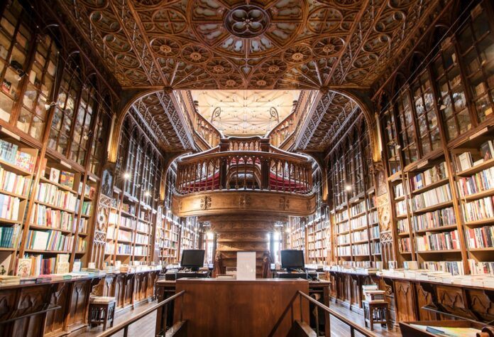 An interior view of the staircase and bookshelves in the Livraria Lello bookshop in Porto, Portugal.