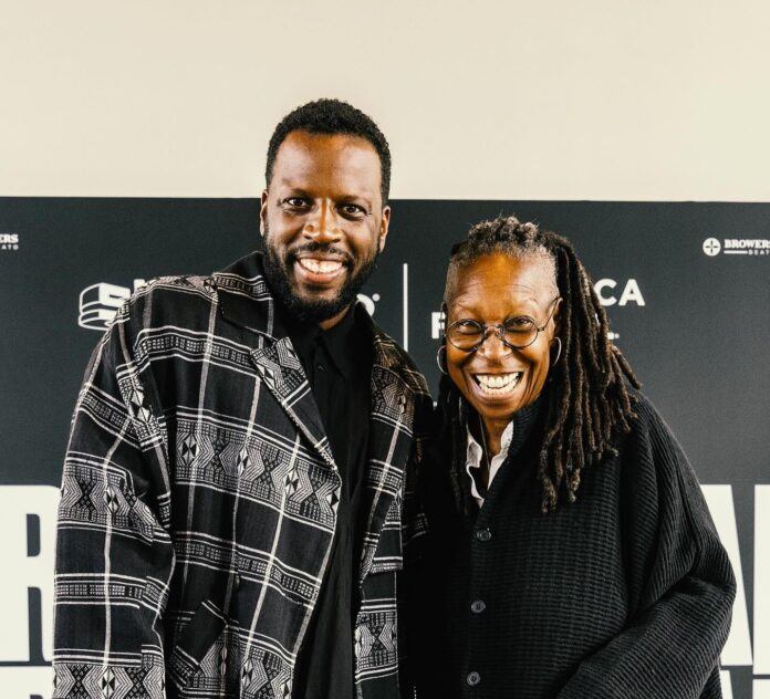 Dino D'Santiago sposes for a photo with actress Whoopi Goldberg in Lisbon.