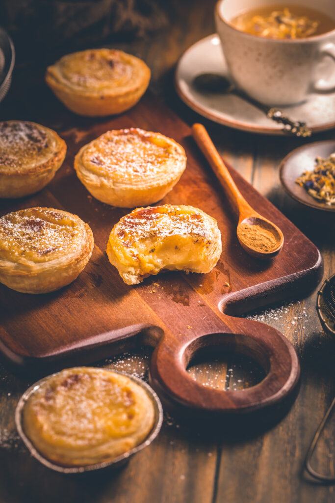 Baked pasteis da nata on a kitchen board