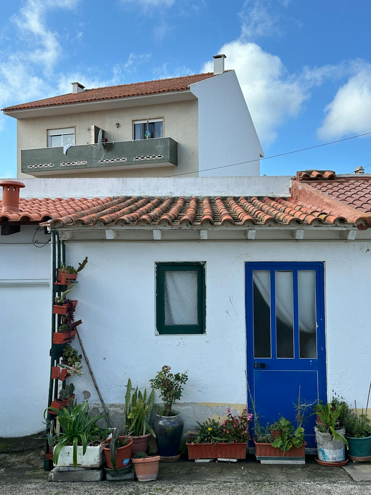 A charming Portuguese House painted white with Blue Door
