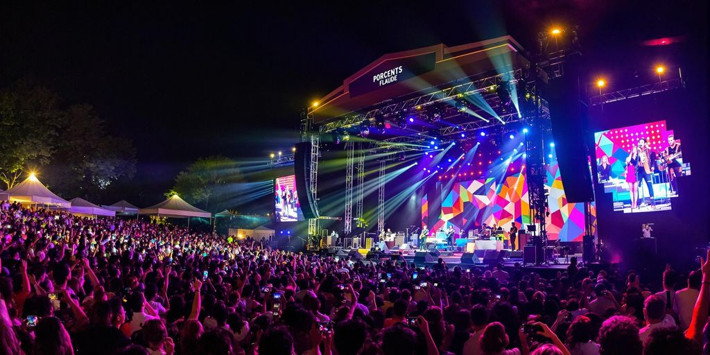 Excited fans at a colorful concert in Portugal.