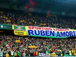 Sporting Lisbon fans celebrate with a large, colorful banner.