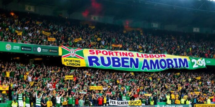 Sporting Lisbon fans celebrate with a large, colorful banner.