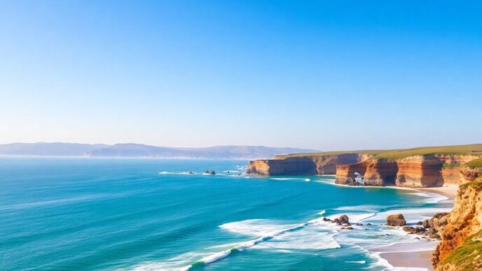 Scenic view of Portugal’s coastline with waves and beach.