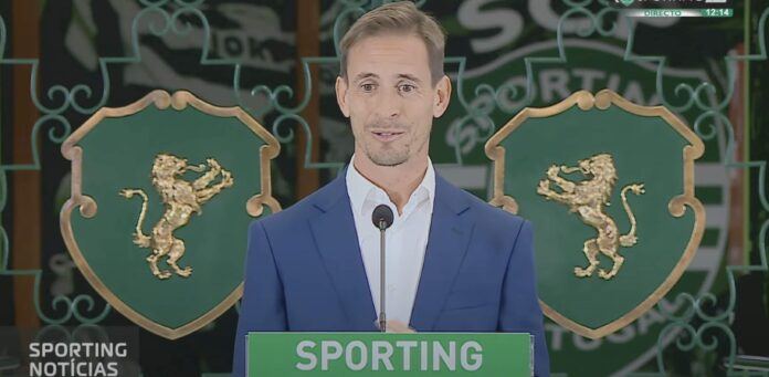 Joao Pereira at a Sporting Lisbon press conference speaking in front of a small microphone.