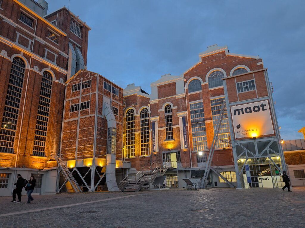 A photo of teh MAAT museum in Lisbon, with lights on at the museum.