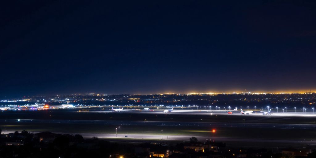 Night view of Lisbon airport with grounded planes.