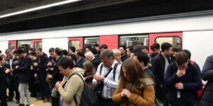 Crowded metro station in Lisbon with anxious commuters.