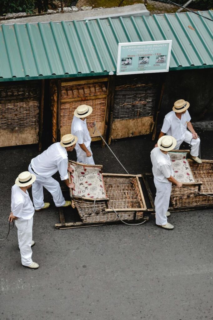 Five Tuk Tuk drivers dressed in white in Funchal