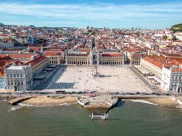 A view of a square in Lisbon seen from high above with the Tagus river in the foreground