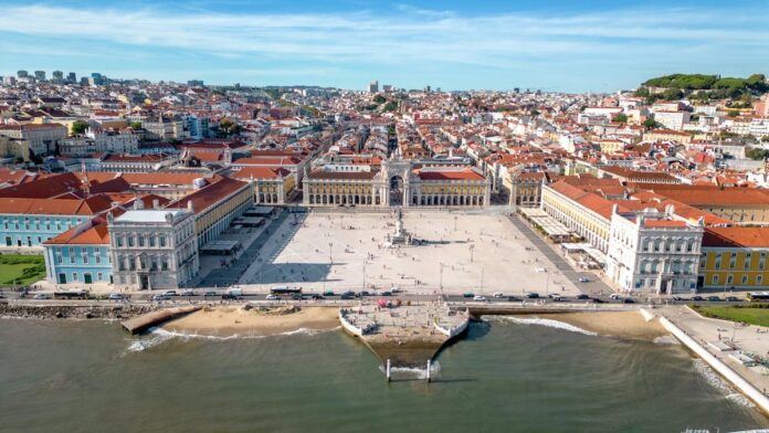 A view of a square in Lisbon seen from high above with the Tagus river in the foreground