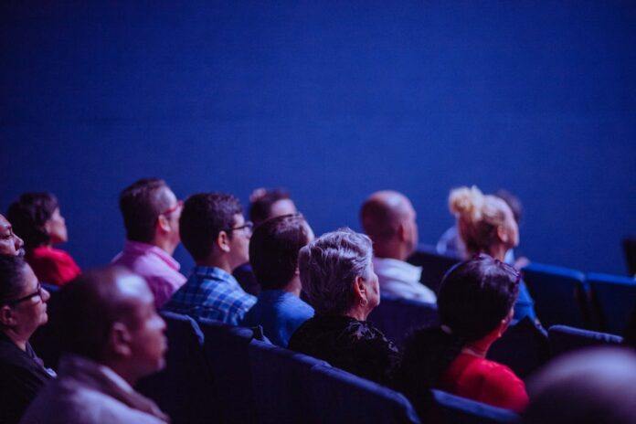 People seated in an auditorium for a cermony