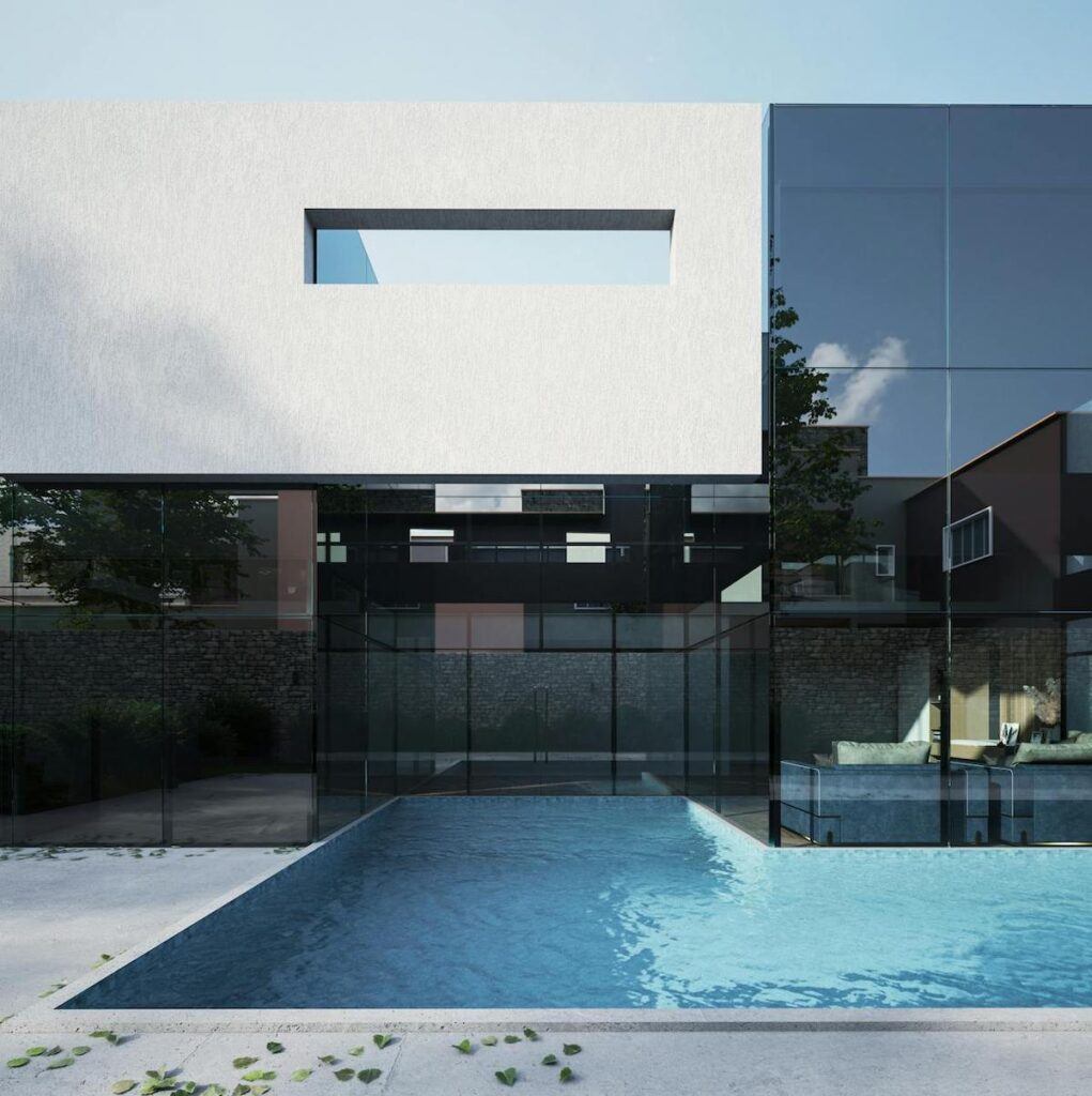 A modernist home pictured with its swimming pool in the foreground