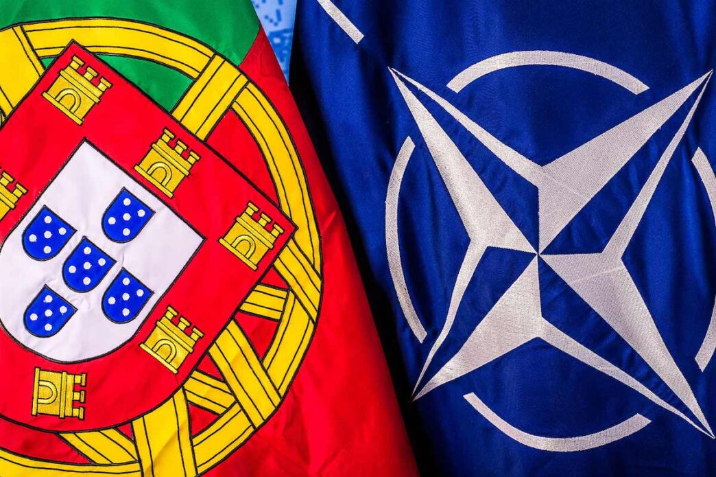 The Portuguese flag hangs beside the NATO flag with both seen close-up