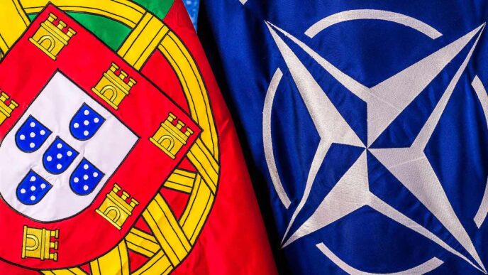 The Portuguese flag hangs beside the NATO flag with both seen close-up