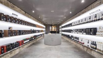 Interior of a Sogevinus shop with shelves filled with wine bottles.