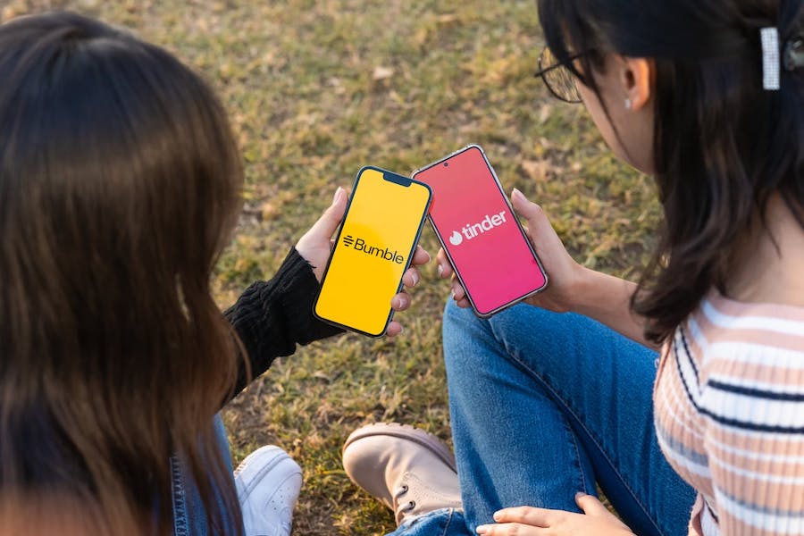 Two women use dating apps on smartphones