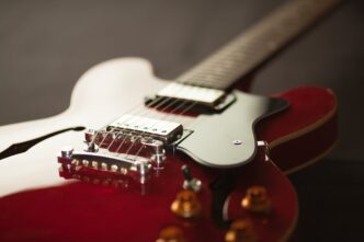 A red electric guitar seen in close-up