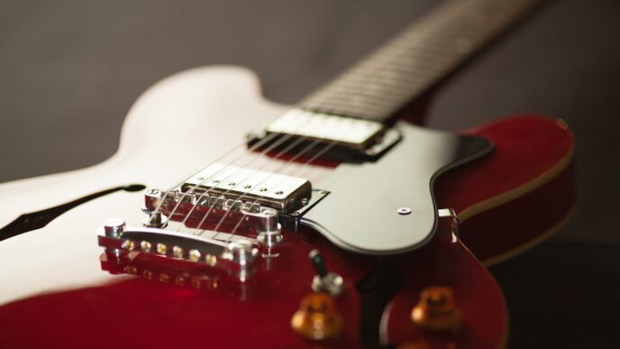 A red electric guitar seen in close-up