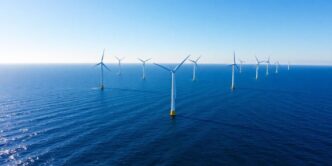 Offshore wind turbines in Portugal against a blue sky.