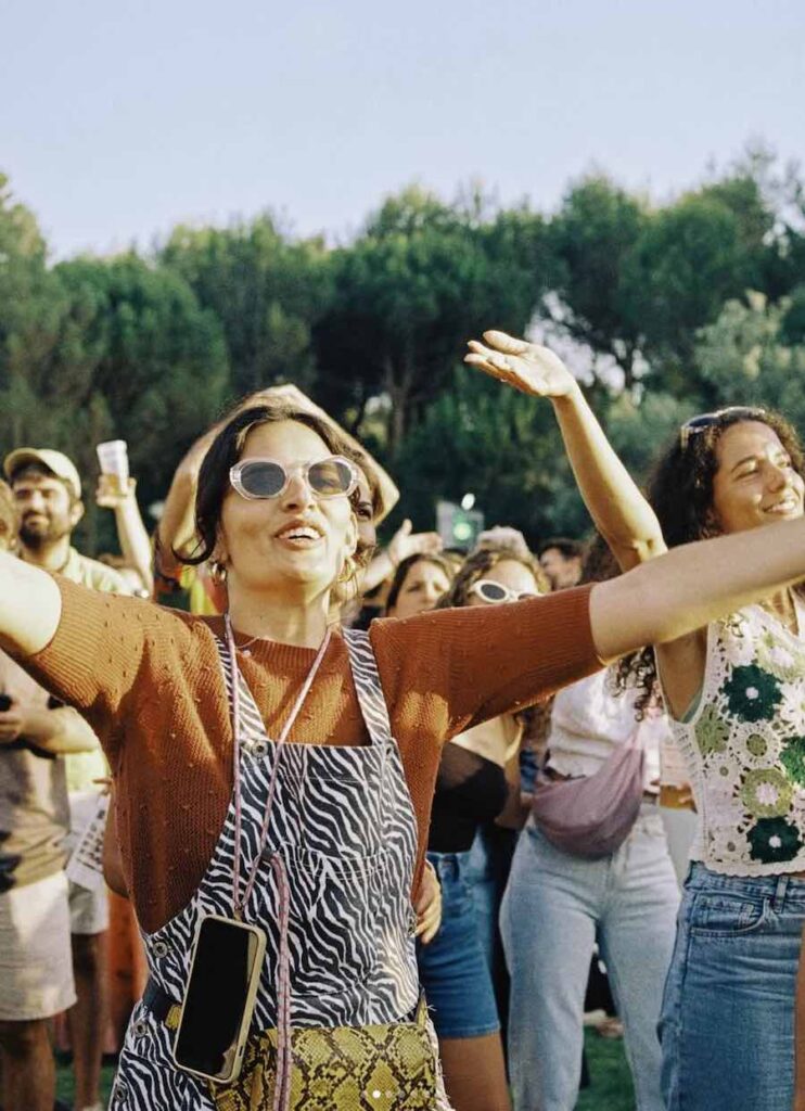 A woman dances in the crowd at a music festival