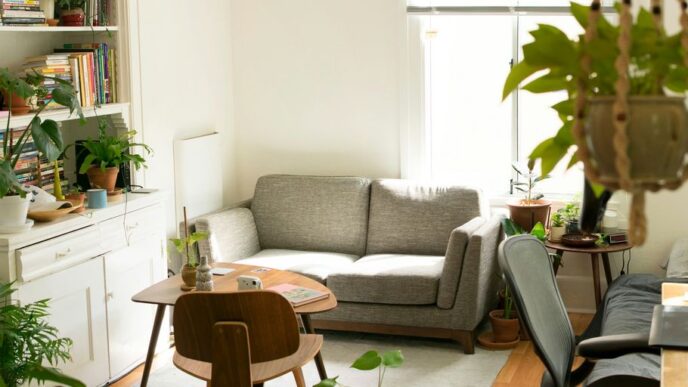 gray fabric loveseat near brown wooden table