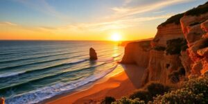 Algarve coast sunset with golden sands and waves.