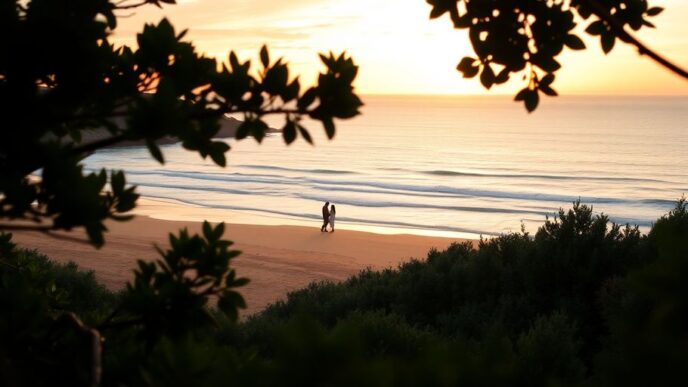 Couple enjoying a romantic sunset on Algarve beach.