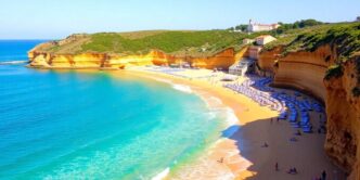 Algarve beach with golden sand and clear blue water.