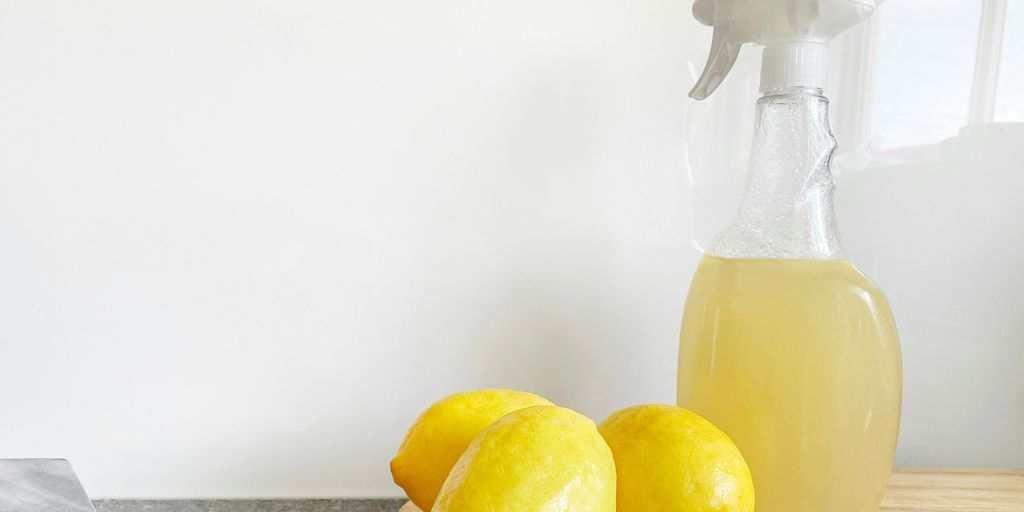 yellow lemon fruit beside clear glass bottle